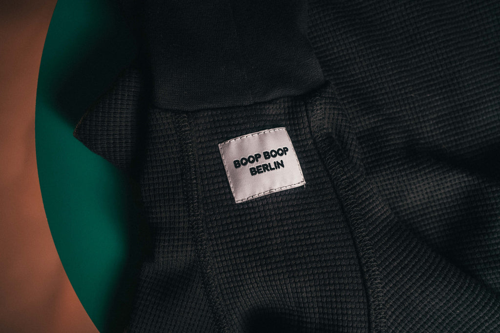 Close-up of the Winona Whippet dog onesie in Licorice with Boop Boop Berlin brand label