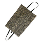 A leopard print dog settle bag with black handles, shown diagonally on a plain white background.